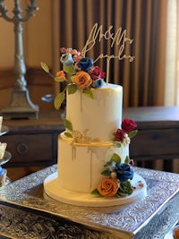 a wedding cake with flowers on top